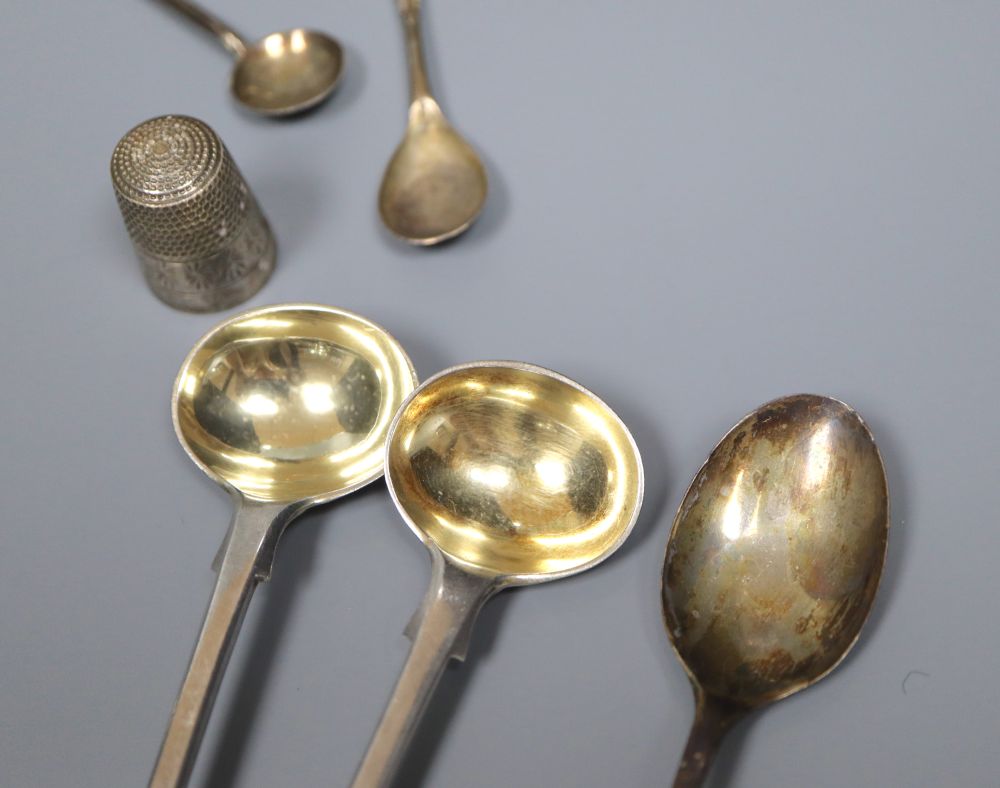 A group of small silverware including small waiter, three condiments, ashtray and minor flatware.